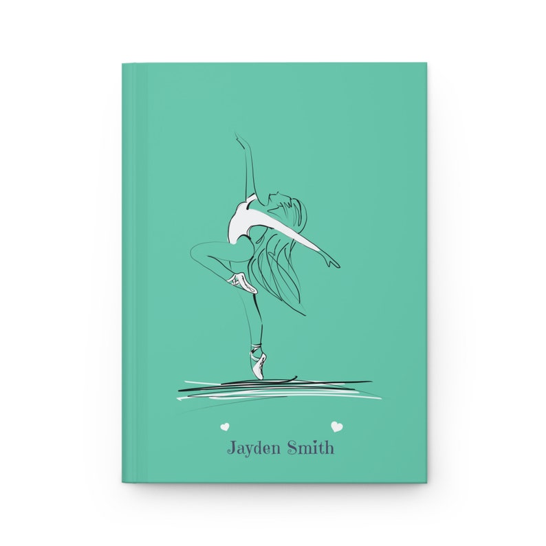 May include: A teal hardcover journal featuring a black and white line art illustration of a ballet dancer in a pose. Below the dancer, the text "Jayden Smith" is printed in a dark gray font, flanked by two small white heart icons.