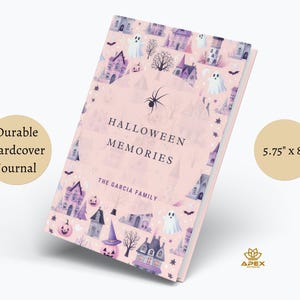 May include: A pink hardcover journal with a Halloween theme. The cover features a pattern of houses, ghosts, bats, and pumpkins. The title "Halloween Memories" is printed on the front cover, along with the text "The Garcia Family". The journal measures 5.75 inches by 8 inches.