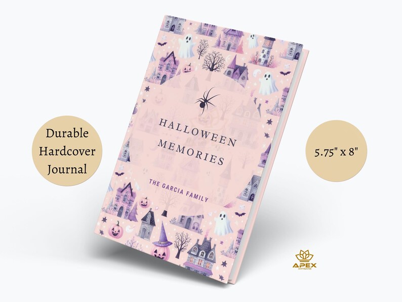 May include: A pink hardcover journal with a Halloween theme. The cover features a pattern of houses, ghosts, bats, and pumpkins. The title "Halloween Memories" is printed on the front cover, along with the text "The Garcia Family". The journal measures 5.75 inches by 8 inches.