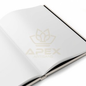 May include: An open book with blank white pages, featuring a light beige cover and a black spine. The center of the pages displays a faint, light beige logo with the text APEX ARTISANS printed in a clean, sans-serif font on the right page.