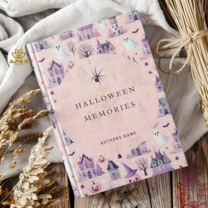 May include: A pink book cover with a Halloween theme. The cover features a pattern of purple houses, ghosts, bats, spiders, and pumpkins. The text "Halloween Memories" is printed in purple on the front cover. The author's name is printed below the title.