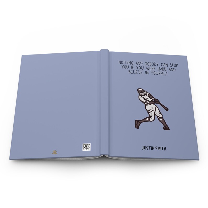 May include: A light blue journal with the text "NOTHING AND NOBODY CAN STOP YOU IF YOU WORK HARD AND BELIEVE IN YOURSELF." and an illustration of a baseball player swinging a bat. The journal is labeled "JUSTIN SMITH".