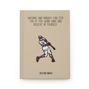 May include: A tan journal with the text "NOTHING AND NOBODY CAN STOP YOU IF YOU WORK HARD AND BELIEVE IN YOURSELF." A baseball player illustration is below the text. The name "JUSTIN SMITH" is printed at the bottom.