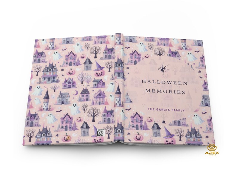 May include: A pink and purple scrapbook with a Halloween theme. The cover features a pattern of houses, ghosts, pumpkins, and bats. The title "Halloween Memories" is printed on the cover, along with the text "The Garcia Family".