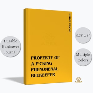 May include: A yellow hardcover journal measuring 5.75 inches by 8 inches. The front cover features the black text: PROPERTY OF A F*CKING PHENOMENAL BEEKEEPER. The spine area includes the name DANIEL SMITH. A small logo for APEX is visible.