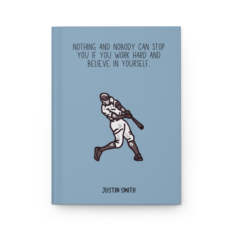 May include: A light blue journal with the text "NOTHING AND NOBODY CAN STOP YOU IF YOU WORK HARD AND BELIEVE IN YOURSELF." A baseball player illustration is featured below the text. The name "JUSTIN SMITH" is printed at the bottom.