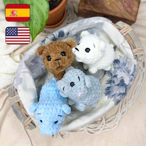 May include: Four crocheted stuffed animals in a wicker basket. The animals are a brown bear, a white polar bear, a light blue pig, and a light blue cat. The basket is lined with a white and blue floral fabric.