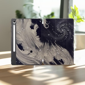 May include: A black tablet case featuring a white swirling abstract design resembling a galaxy with scattered four-pointed stars. The case is open, displaying a smooth interior surface, and includes a dedicated vertical slot for a stylus pen.