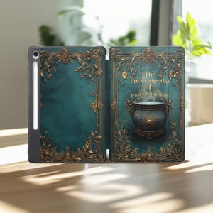 May include: A teal tablet case with gold filigree and the text "The Encyclopedia of Potion making" on the cover. The cover features an illustration of a cauldron with steam rising from it. The case is open, revealing the tablet screen.