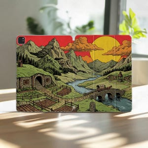 May include: A tablet case featuring a colorful illustration of a landscape with green hills, mountains, a winding river, a stone bridge with a horse-drawn wagon, and a round-door dwelling under a large yellow sun and orange sky.