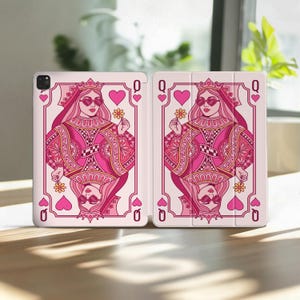 May include: A pink and white tablet case featuring a Queen of Hearts playing card design. The illustration shows a queen wearing sunglasses and holding a flower. The case is open, displaying the design on both sides.