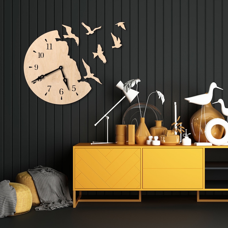 May include: A yellow dresser with a chevron pattern on the front. The dresser has two drawers and three shelves. There are various decorative items on top of the dresser, including vases, lamps, and figurines. A wooden clock with a bird design is on the wall behind the dresser.