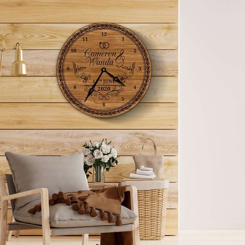 May include: A wooden clock with a brown background and black lettering. The clock face features the names "Cameron & Wanda" and the date "1st June 2020".