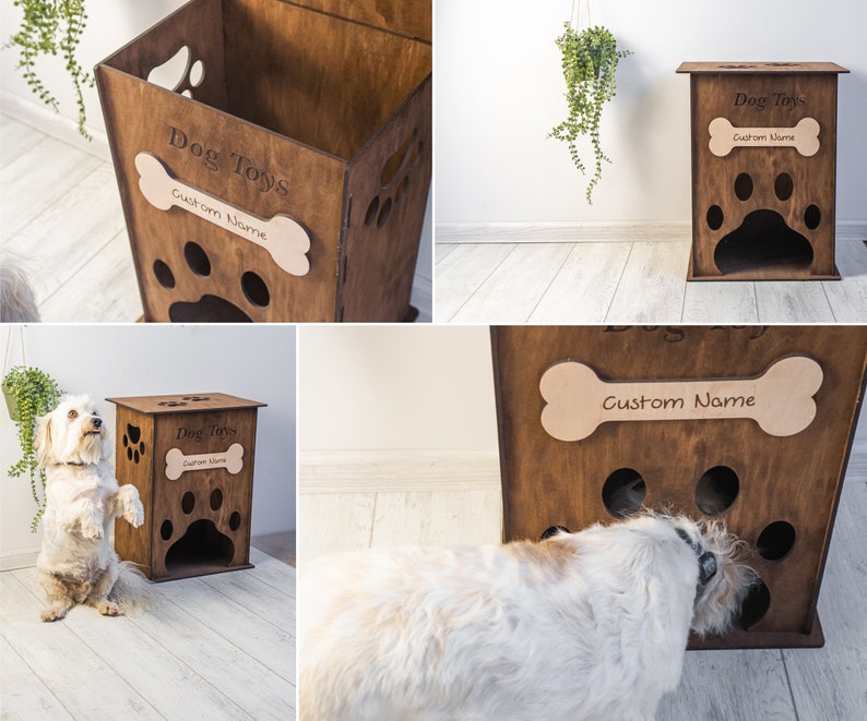 May include: A wooden dog toy storage box with paw-shaped cutouts and a bone-shaped name tag. The box is engraved with "Dog Toys" and "Custom Name". The box is brown and has a rectangular shape.