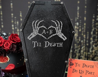 May include: Black coffin-shaped guest book with a sign that reads "Til Death Do Us Part" and "Please Sign a Heart Drop it into the guest book so we will never forget our loved ones who came A+B".