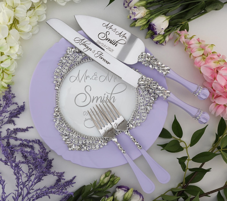 May include: A set of wedding cake cutting knives and forks with lavender handles. The knives are engraved with "Mr. & Mrs. Smith 09.03.2025 Always & Forever" and the forks are engraved with "Always & Forever".