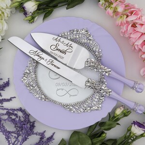 May include: A lavender cake server set with a silver knife and server. The knife has the text "Always & Forever" and the server has the text "Mr. & Mrs. Smith 09/03/2025".