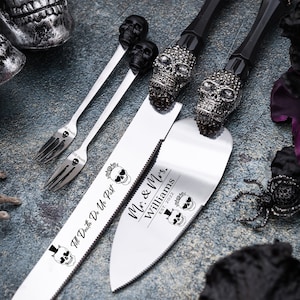 May include: A wedding cake cutting set with black skull handles and silver blades. The blades are engraved with the text "Till Death Do Us Part" and "Mr. & Mrs. Williams Est. 2022".