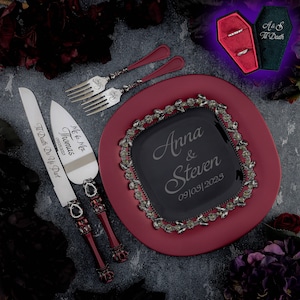 May include: A red and black wedding cake serving set with a knife and server. The knife has the inscription "Mc & Mrs. Thomas 09/09/2003 Til Death Do Us Part". The server has a black and red handle with a crown design. The cake plate is red with a black square in the center with the inscription "Anna & Steven 09/03/2023".