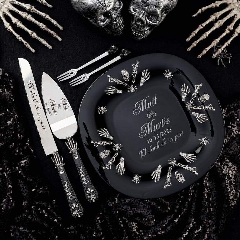 May include: A black glass cake plate with a silver skeleton hand design and the names Matt and Martie, the date 10/13/2023, and the phrase "Till death do us part" engraved on the plate. A silver cake knife and server with skeleton hand handles and the same text engraved on the blades.