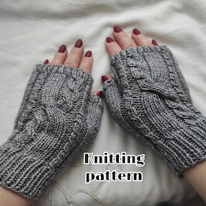 May include: A pair of gray knitted fingerless gloves with a cable knit design. The gloves are displayed on a white surface. The words "Knitting pattern" are written in black text.
