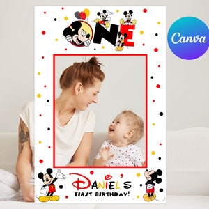 Puede incluir: Un marco de fotomatón blanco con borde rojo, con gráficos de Mickey Mouse y la palabra "ONE" en letras grandes. El marco incluye el texto "Daniel's First Birthday!" y está decorado con lunares rojos, amarillos y negros.