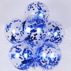 May include: A cluster of clear balloons filled with blue confetti. The balloons are tied together and ready for a party.
