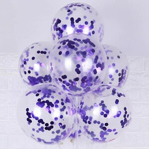 May include: A bunch of clear balloons with purple confetti inside. The balloons are tied together and ready for a party.