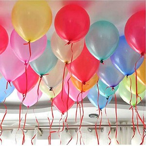 May include: A group of colorful balloons tied together with red ribbons. The balloons are a mix of pastel colors, including pink, blue, yellow, and green.