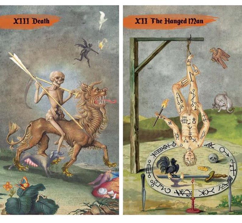 May include: Two tarot cards with illustrations. The first card, "XIII Death," depicts a skeletal figure riding a lion-like creature. The second card, "XII The Hanged Man," shows a person hanging upside down. Both cards have text in the upper corners.