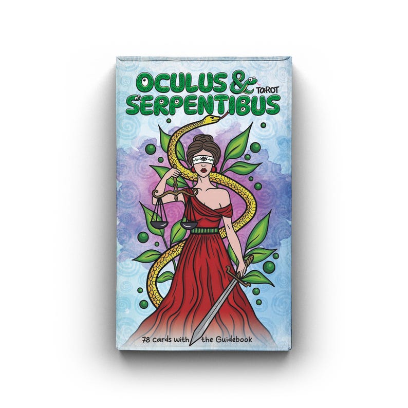 May include: A tarot card deck titled "Oculus & Serpentibus" featuring an illustration of a blindfolded woman in a red dress holding scales and a sword, with a yellow snake and green leaves. The deck contains 78 cards with a guidebook.