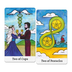 May include: Two tarot cards. The first card, "Two of Cups," depicts a couple toasting with golden goblets. The second card, "Two of Pentacles," shows two pentacles within a green, serpentine shape. Both cards have a blue sky background.