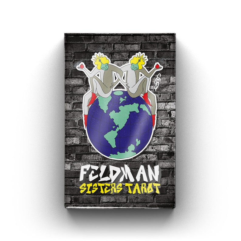 May include: A black and white brick background with a colorful illustration of two figures sitting on a globe. The globe is blue with green continents. The text "Feldman Sisters Tarot" is written in yellow and black letters.
