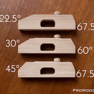 Puede incluir: Tres bloques de ángulo de madera con un asa y una perilla en la parte superior. Los bloques están etiquetados con los ángulos 22,5 grados, 30 grados y 45 grados. Los bloques están etiquetados con los ángulos 67,5 grados, 60 grados y 67,5 grados. Los bloques están hechos por PROWOOD.