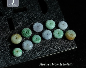 May include: A collection of natural, untreated Burmese jadeite donut beads. The beads are carved with intricate designs and have a light green and lavender color.
