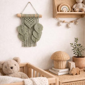 May include: A nursery scene with a wooden crib, a macrame wall hanging, and a shelf with a stuffed bunny and rainbow. A woven mushroom-shaped basket sits on a dresser with a teddy bear.