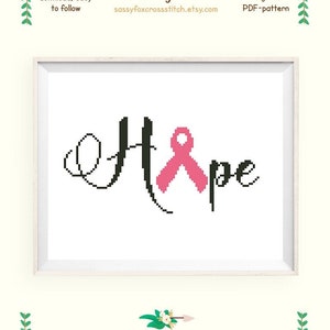 Peut inclure: Modèle de point de croix pour "Hope" avec un ruban rose, conçu pour une toile Aida 14. Le motif mesure 17,2 x 8,5 cm (6,8 x 3,3 pouces) et utilise 2 couleurs de fil DMC.