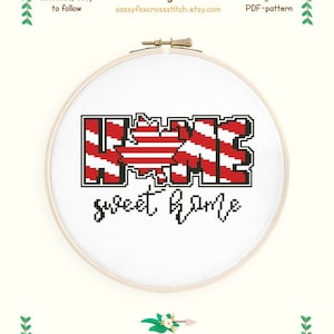 Puede incluir: Patrón de punto de cruz para un diseño de hogar dulce hogar con una bandera canadiense roja y blanca en el medio de la palabra "hogar". El patrón mide 14,9 cm por 9,6 cm y utiliza 2 colores de hilo DMC.