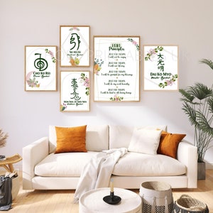 May include: Five framed prints with floral designs and Japanese characters. The prints are hung on a white wall above a white couch with orange throw pillows. The prints feature the Japanese characters for "Cho Ku Rei", "Sei Heiki", "Hon Sha Ze Sho Nen", "Reiki Principles", and "Dai Ko Myo".