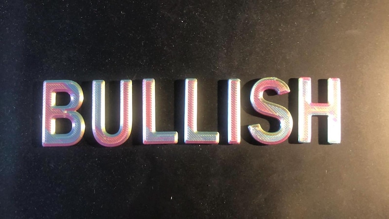 May include: The word "BULLISH" spelled out in iridescent pink and blue letters.