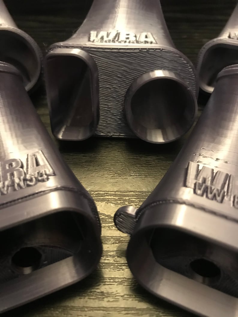 May include: Four 3D printed purple plastic exhaust tips with the word "WARA" printed on each.