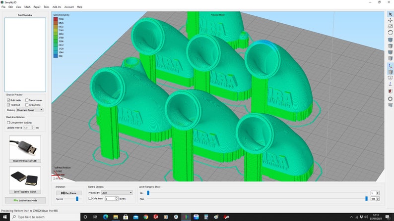 May include: A 3D printed model of a green plastic elbow pipe fitting. The fitting has a round opening on one end and a rectangular opening on the other end. The fitting is labeled "MARA" on the side.