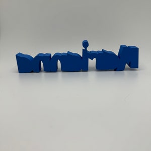 May include: A blue plastic word spelled "mom" in a stylized font.