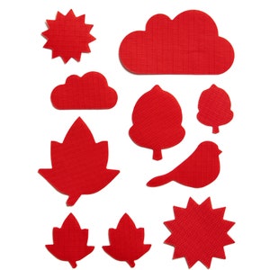 Puede incluir: Formas de fieltro rojo de un sol, una nube, dos hojas, un pájaro, un árbol y una estrella. Estas formas son perfectas para proyectos de manualidades.