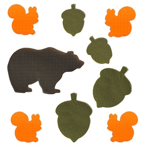 May include: A brown bear silhouette with five orange squirrels and five green acorns on a white background.