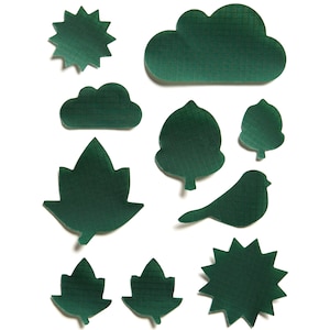 May include: A set of ten green felt cutouts in the shapes of a cloud, a sun, a bird, a leaf, and a tree. The cutouts are all outlined in a grid pattern.