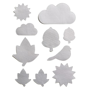 May include: A set of ten grey felt shapes, including a sun, a cloud, a bird, a tree, and leaves. The shapes are all cut out and have a textured surface.