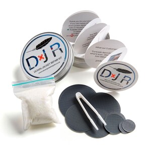 May include: A silver tin with a white label that says "DJR Down Jacket Repair Kit" and a feather icon. The tin contains a small bag of white down feathers, a pair of tweezers, and a set of gray fabric patches.