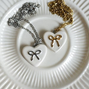 Ceramic Heart Shape Pendant Necklace with Bow, Handmade ceramic jewelry, Gift for her, Unique ceramic necklace, Silver and Gold Bow