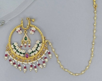 May include: Gold nose ring with a circular design, featuring white and green beads, pink stones, and a dangling chain.